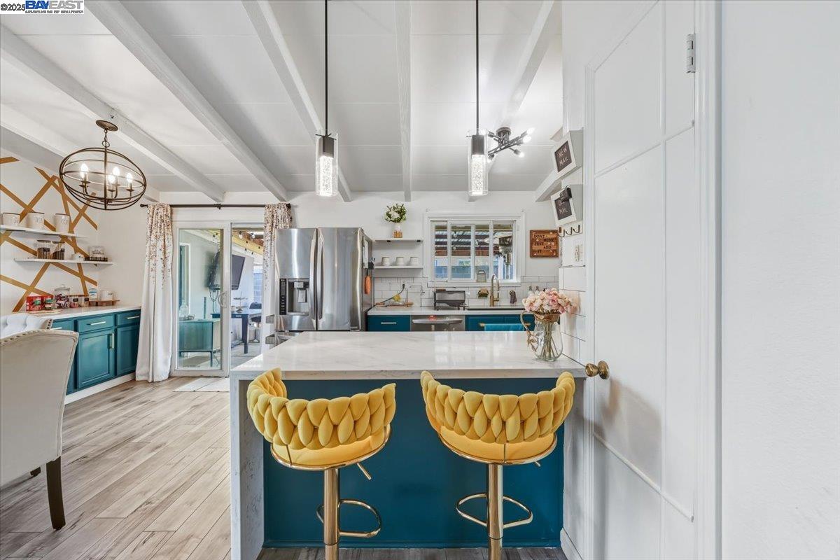 1481 Rieger Avenue Hayward, CA 94544 - Photo 28 of 53 a large living room with kitchen island furniture and a chandelier