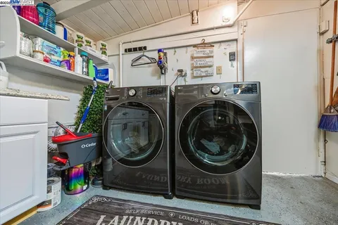 a view of a patio with table and chairs with barbeque grill and wooden floor