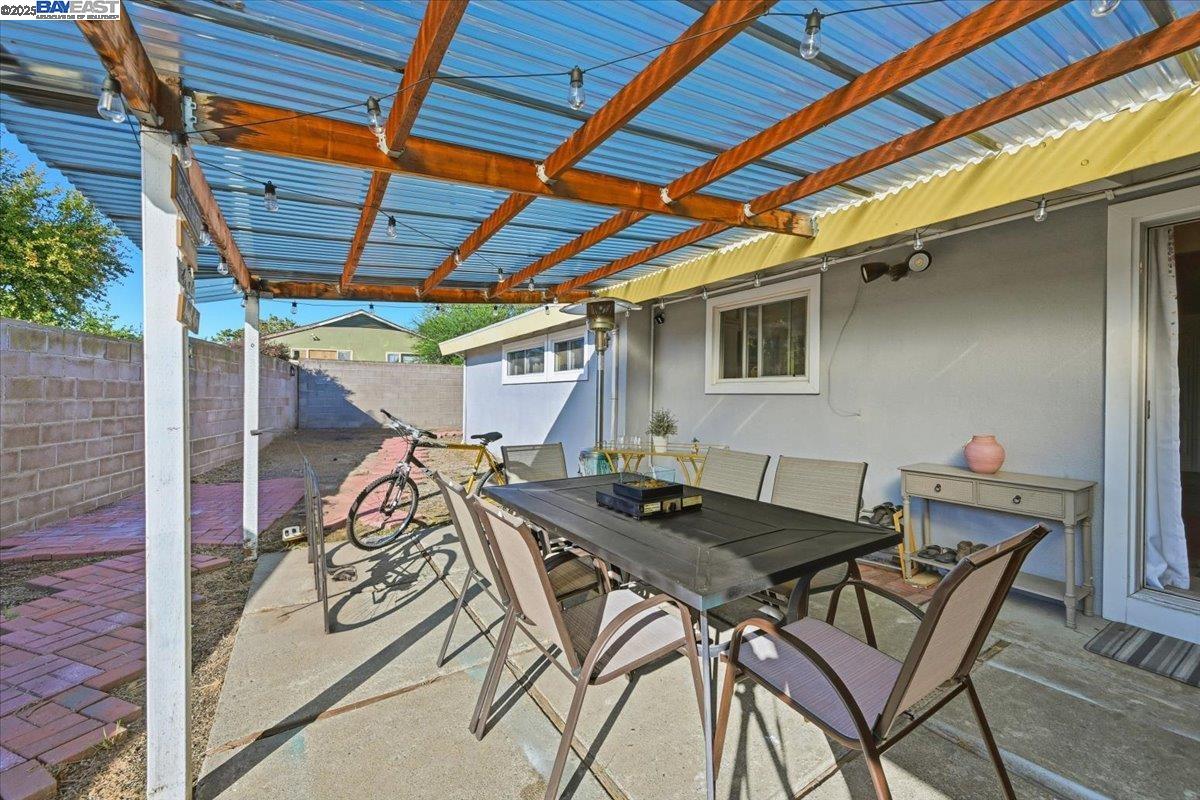 1481 Rieger Avenue Hayward, CA 94544 - Photo 47 of 53 a view of a patio with table and chairs with barbeque grill and wooden floor