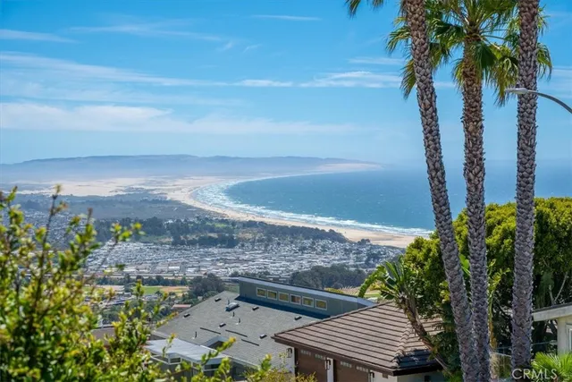 a kitchen with stainless steel appliances kitchen island granite countertop a table chairs sink and cabinets