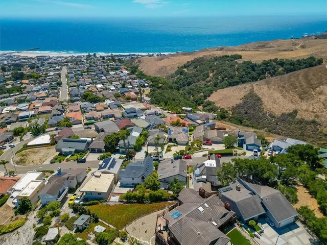 a front view of a house with yard and parking