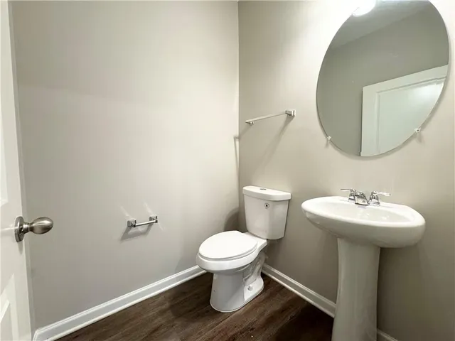 a bathroom with a sink toilet and a mirror
