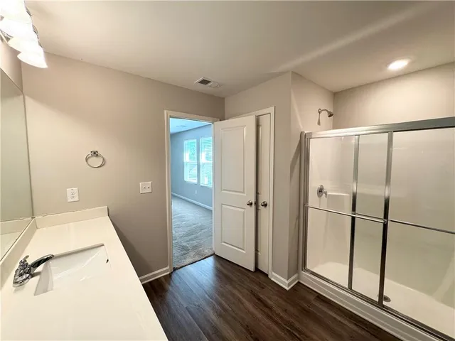 a view of a kitchen with a sink and refrigerator