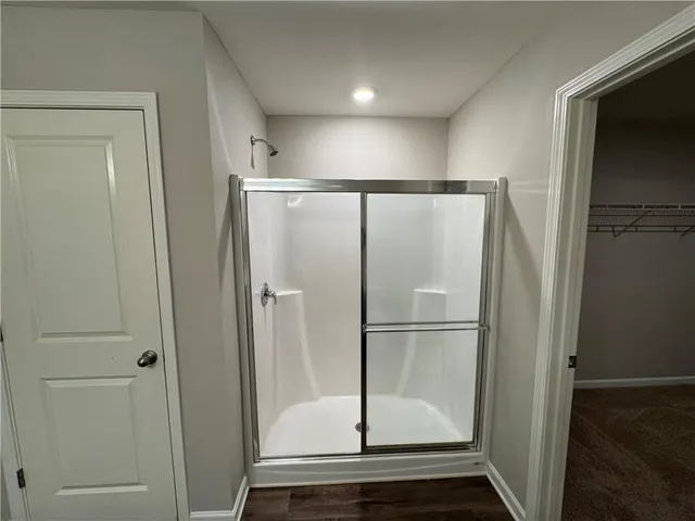 a bathroom with a glass shower door