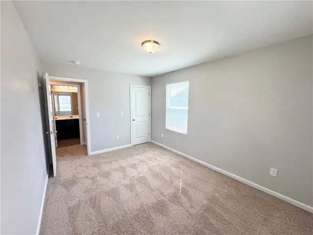 an empty room with windows and cabinet
