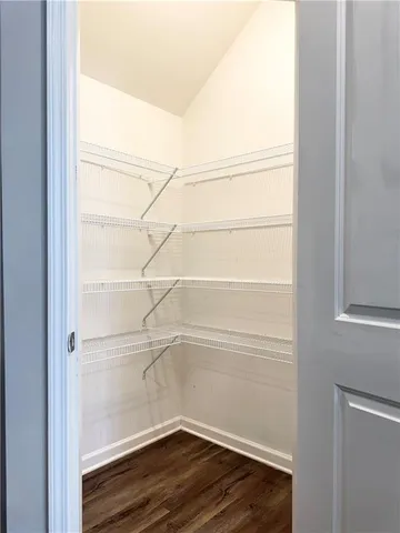 a empty closet with wooden floor