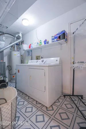 a utility room with a refrigerator and cabinets
