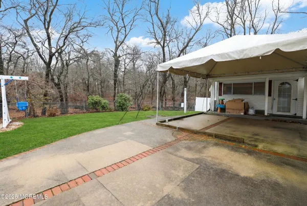 a view of a white house with a yard