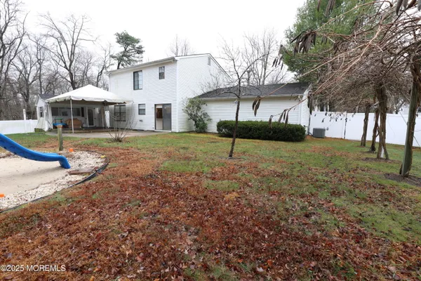 a view of a house with a yard and sitting area