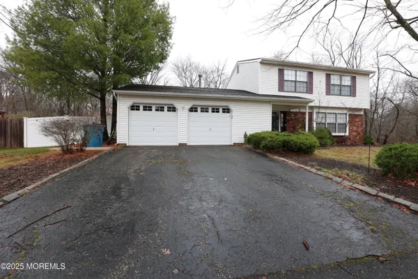 a view of house with outdoor space and parking