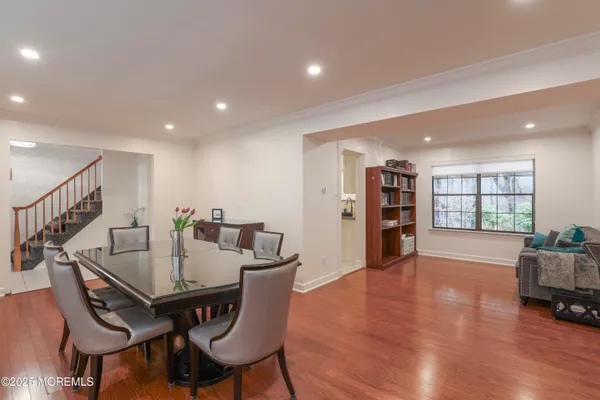 a view of a livingroom with furniture and a book shelf