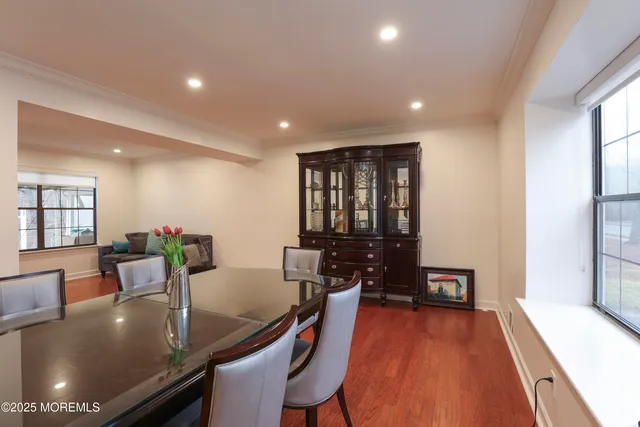 a dining room with furniture and wooden floor