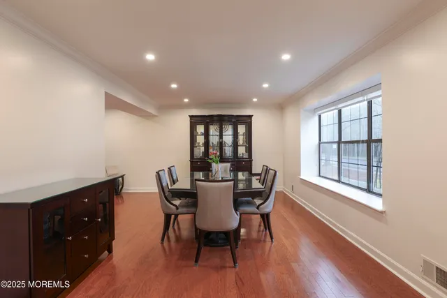 a dining room with furniture and wooden floor