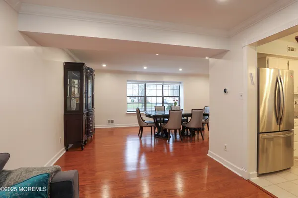 a dining room with furniture and wooden floor
