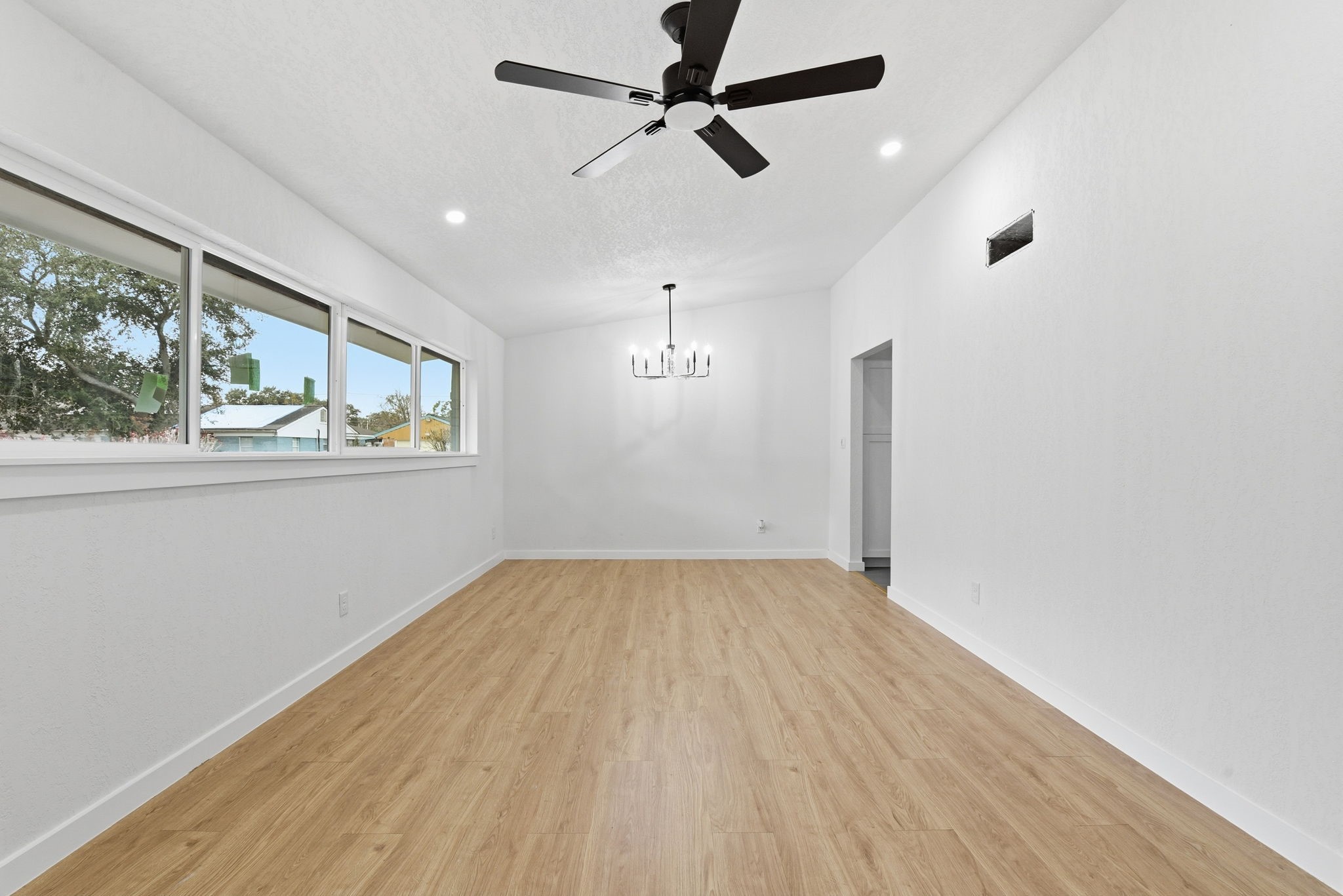 12319 Renwick Houston, TX 77035 - Photo 14 of 50 an empty room with wooden floor and windows