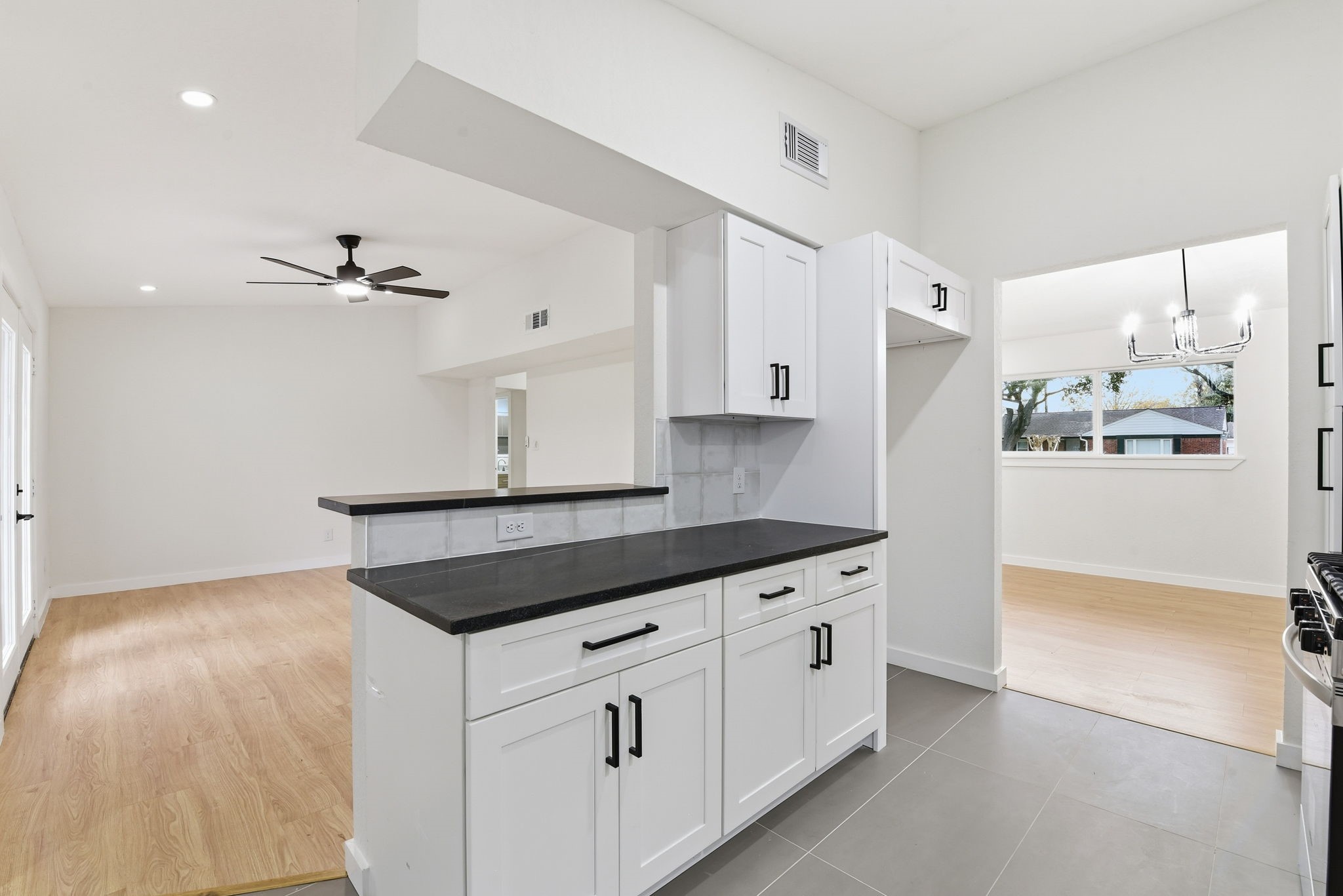12319 Renwick Houston, TX 77035 - Photo 18 of 50 a kitchen with granite countertop a white cabinets and white appliances