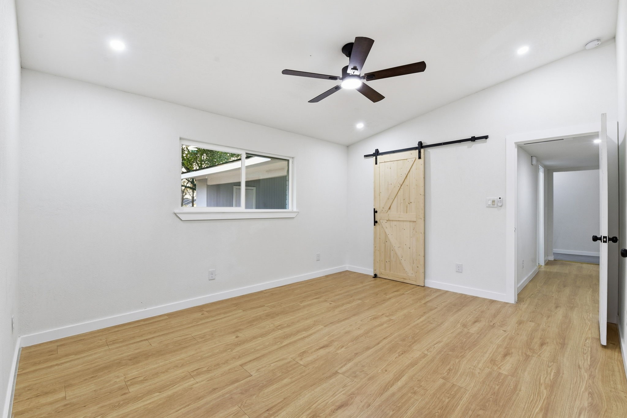 12319 Renwick Houston, TX 77035 - Photo 31 of 50 a view of empty room with wooden floor and ceiling fan