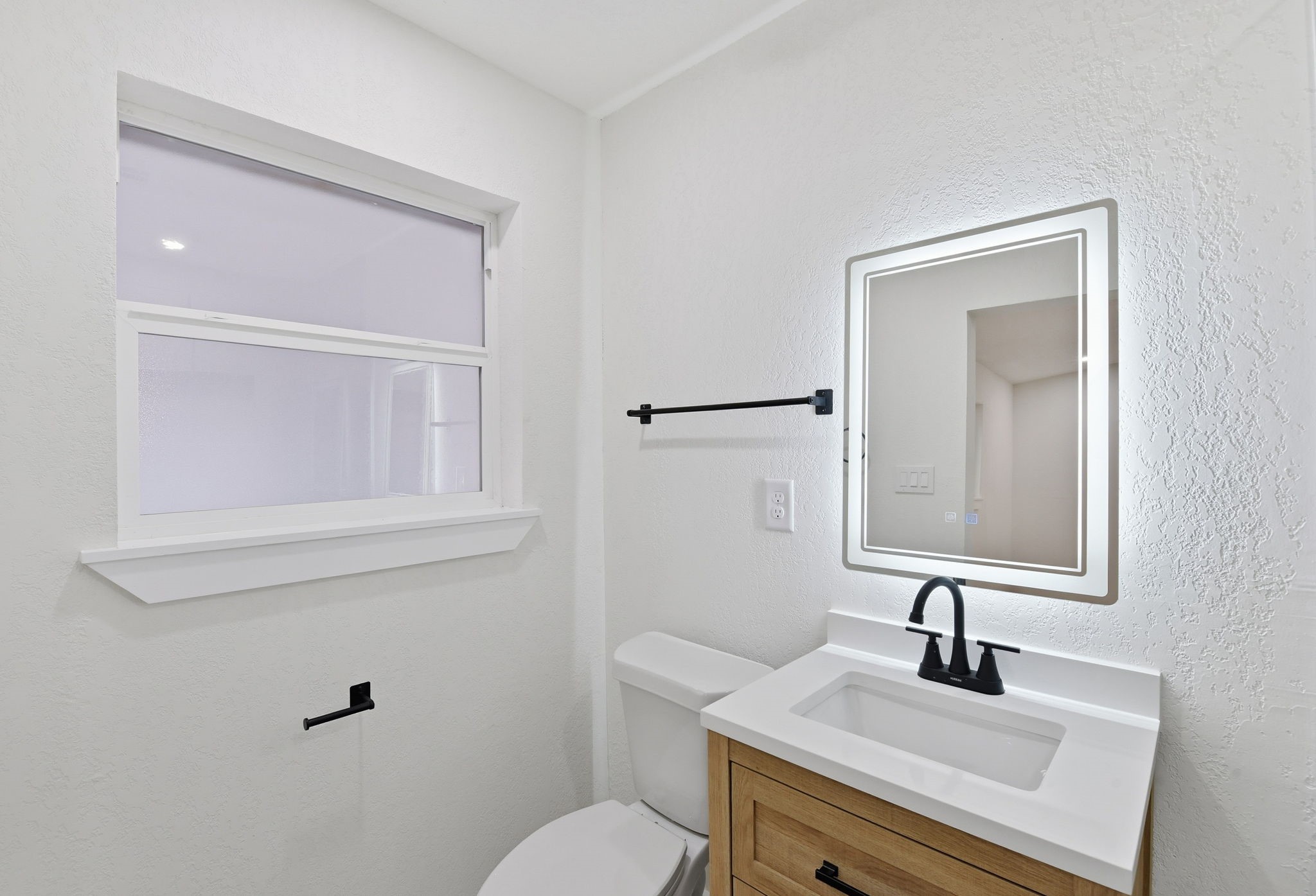 12319 Renwick Houston, TX 77035 - Photo 35 of 50 a bathroom with a sink vanity mirror and toilet