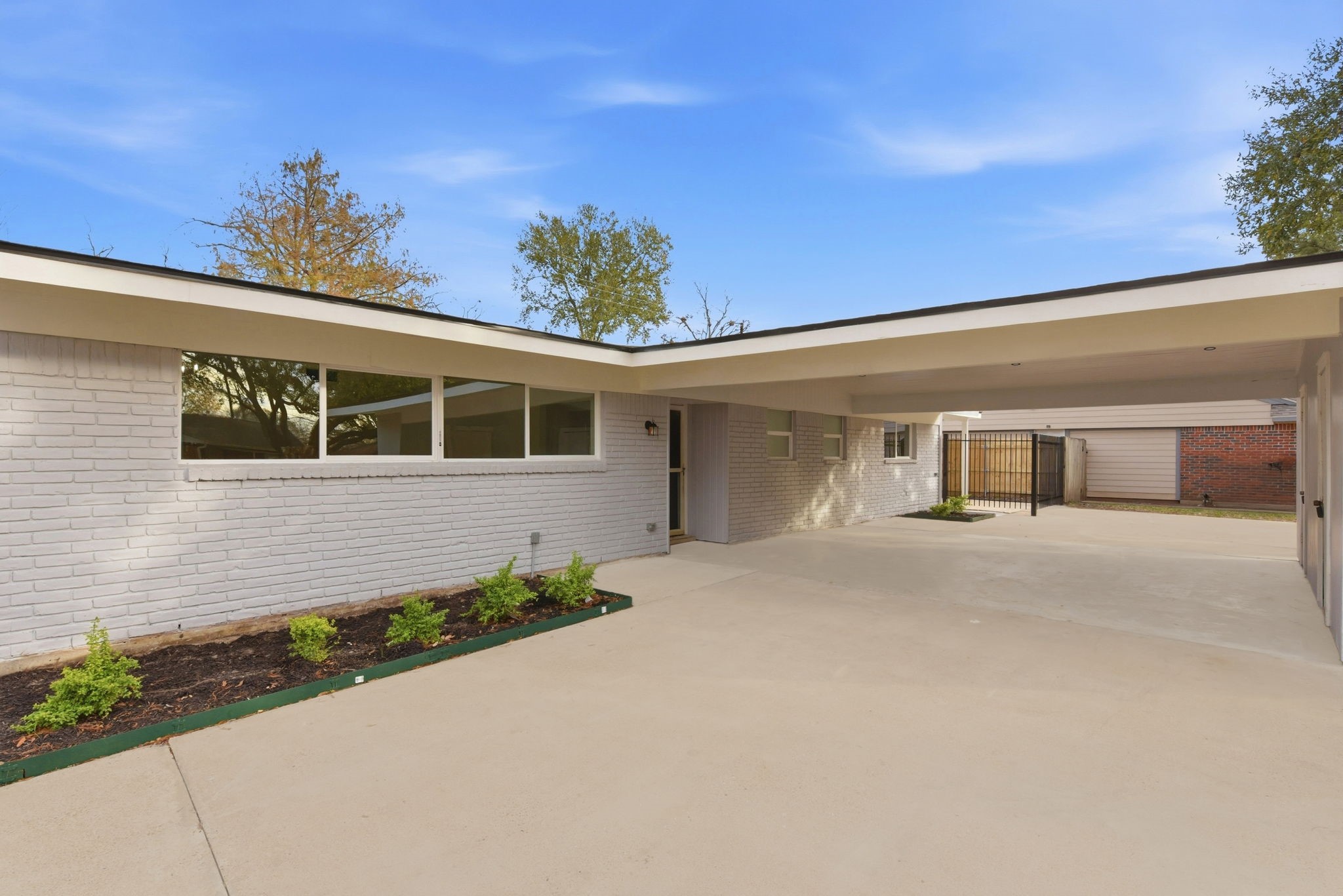 12319 Renwick Houston, TX 77035 - Photo 7 of 50 a front view of a house with a yard and a garage