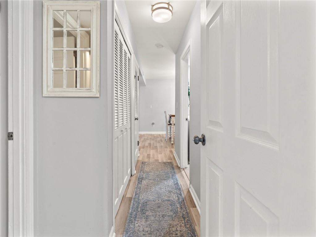 6851 Roswell Road, Unit H26 Atlanta, GA 30328 - Photo 26 of 49 a view of a hallway with wooden floor and staircase