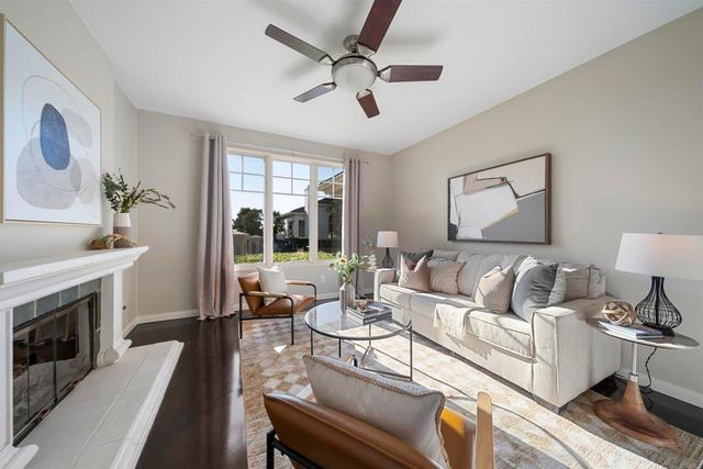 a living room with furniture fireplace and a large window
