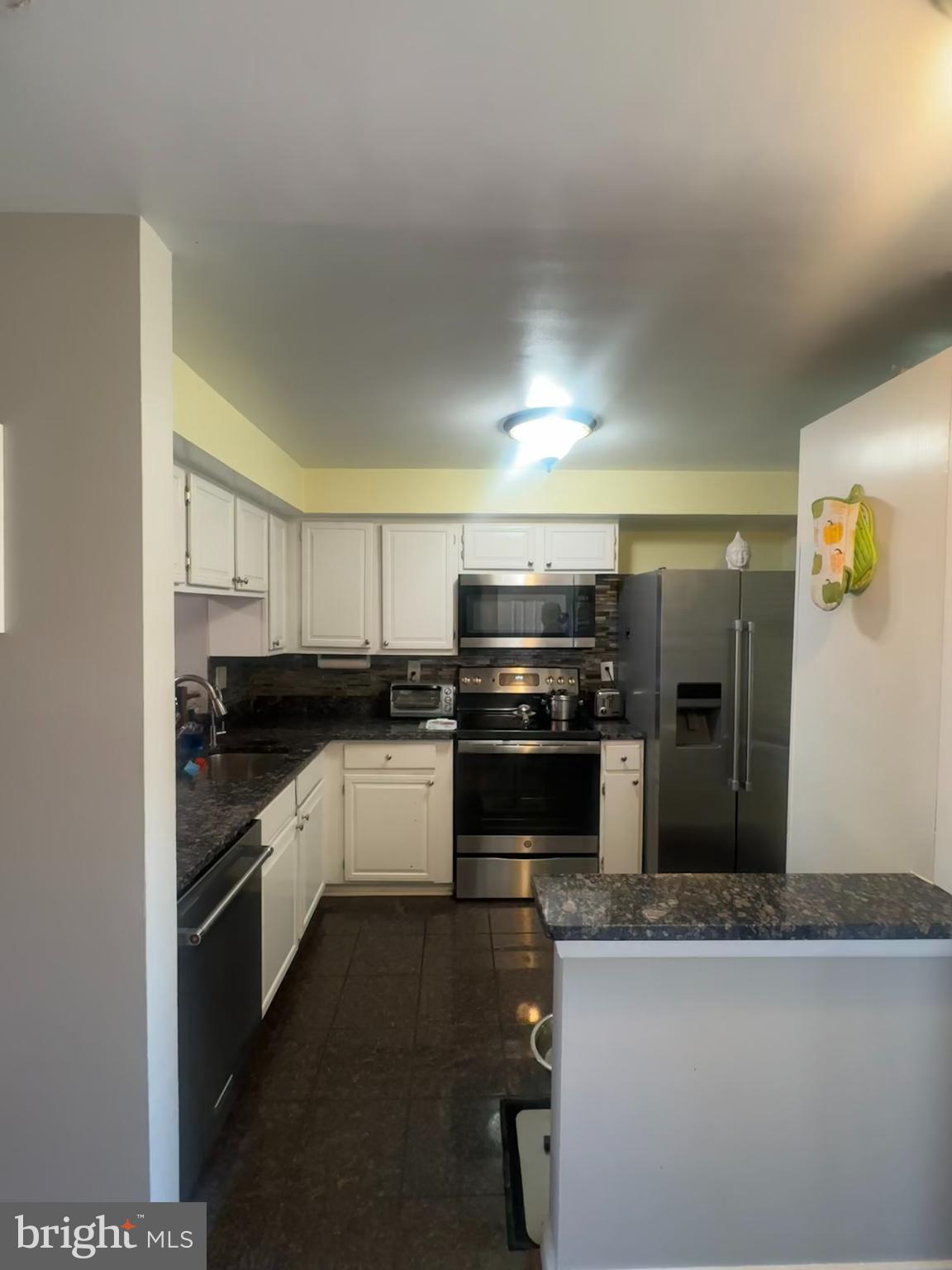 14560 Farmcrest Place Silver Spring, MD 20905 - Photo 5 of 11 a kitchen with a sink and stainless steel appliances