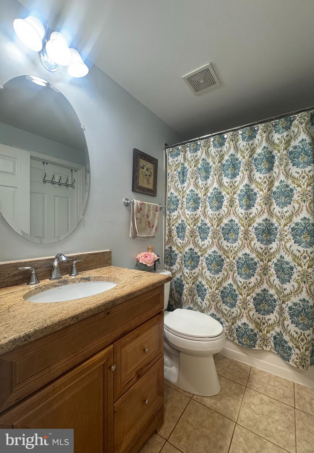 14560 Farmcrest Place Silver Spring, MD 20905 - Photo 7 of 11 a bathroom with a granite countertop sink a toilet and a mirror