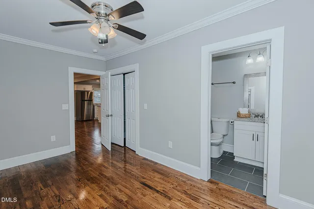 wooden floor in an empty room with a bathroom
