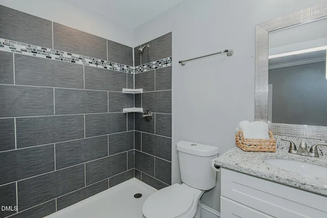 a bathroom with a toilet a sink and shower