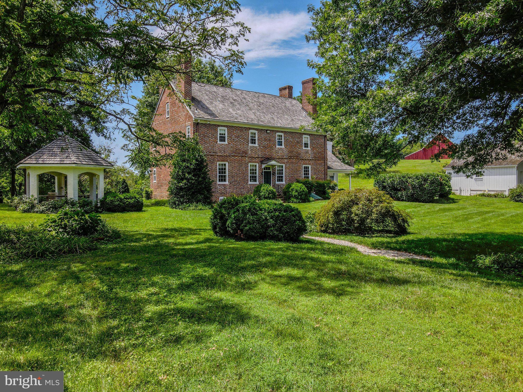 246 Mill Swamp Road Edgewater, MD 21037 - Photo 20 of 29 Charming brick home amid lush greenery.