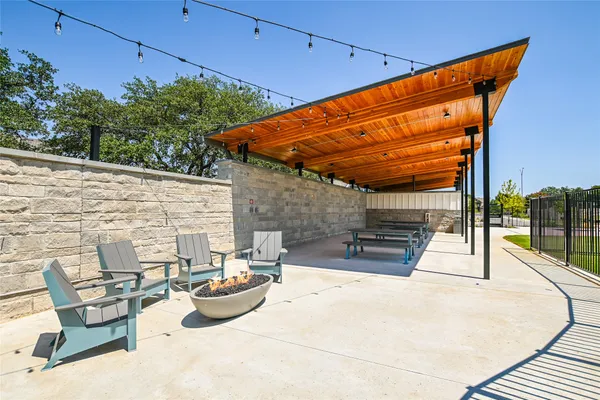 a view of a patio with a table and chairs and potted plants