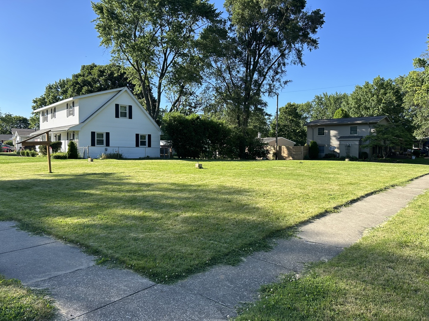 a view of an house with swimming pool and trees in the background