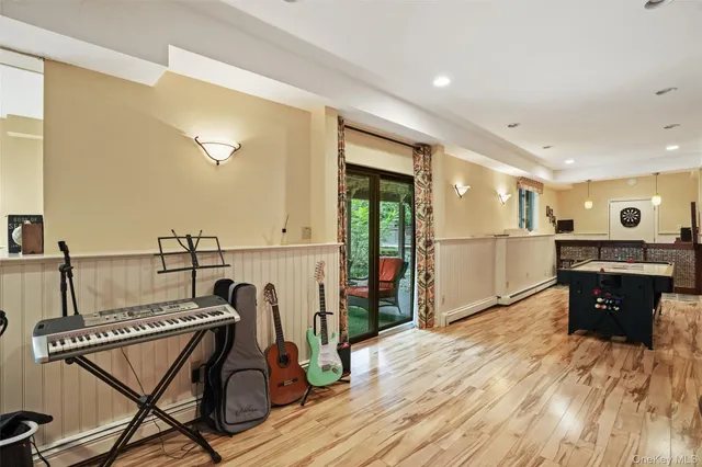 a view of a kitchen with furniture and wooden floor