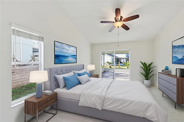 a bedroom with a large bed and a chandelier