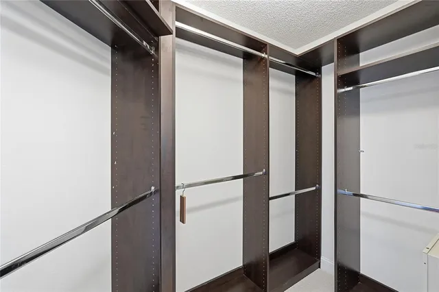 a view of walk in closet with wooden floor