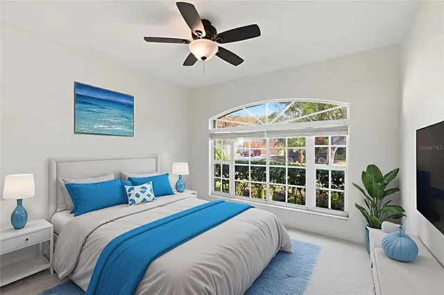 a bedroom with a large bed and a large window