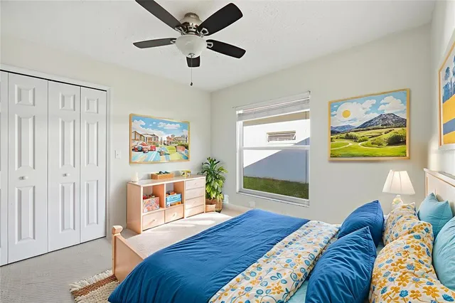 a bedroom with a bed and a painting on the wall
