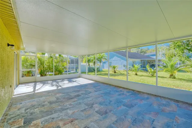 a view of a house with a yard and potted plants