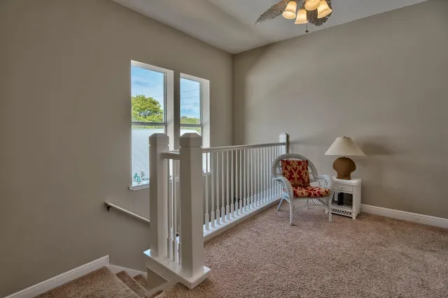 a view of a room with a dining table and chairs