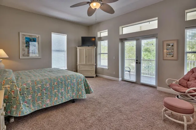 a spacious bedroom with a bed and ceiling fan