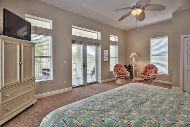 a spacious bedroom with a bed and large windows