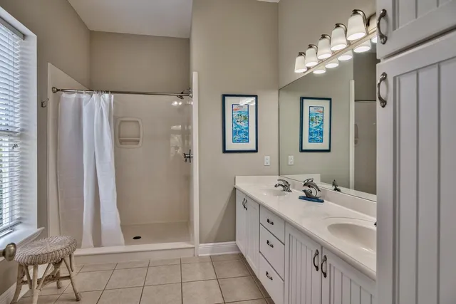 a bathroom with a double vanity sink mirror and double