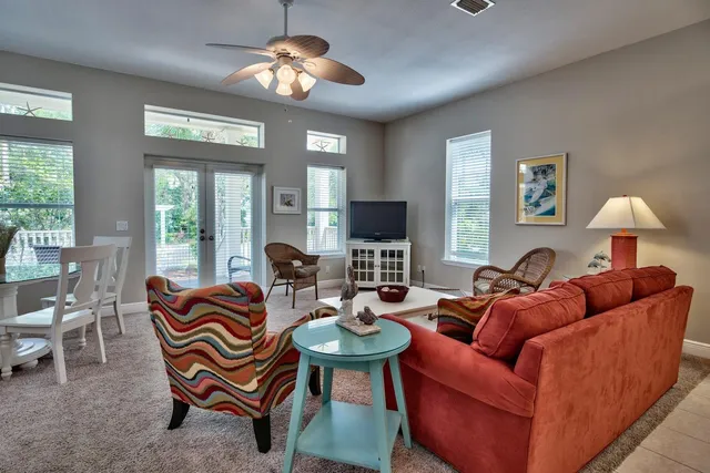 a living room with furniture a large window and a flat screen tv