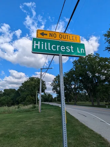 a sign board with a play ground in the back