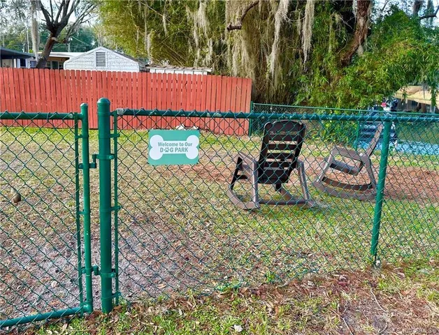 a view of a wooden deck with chairs and a yard