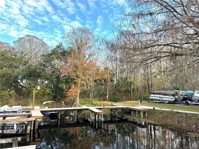 a view of backyard with swimming pool and seating