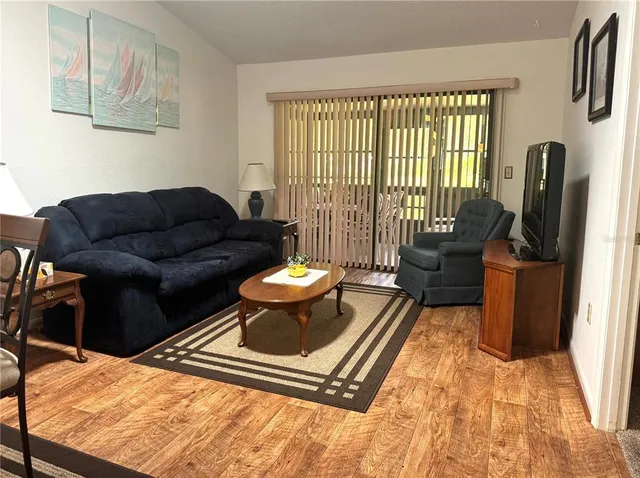 a living room with furniture and a floor to ceiling window