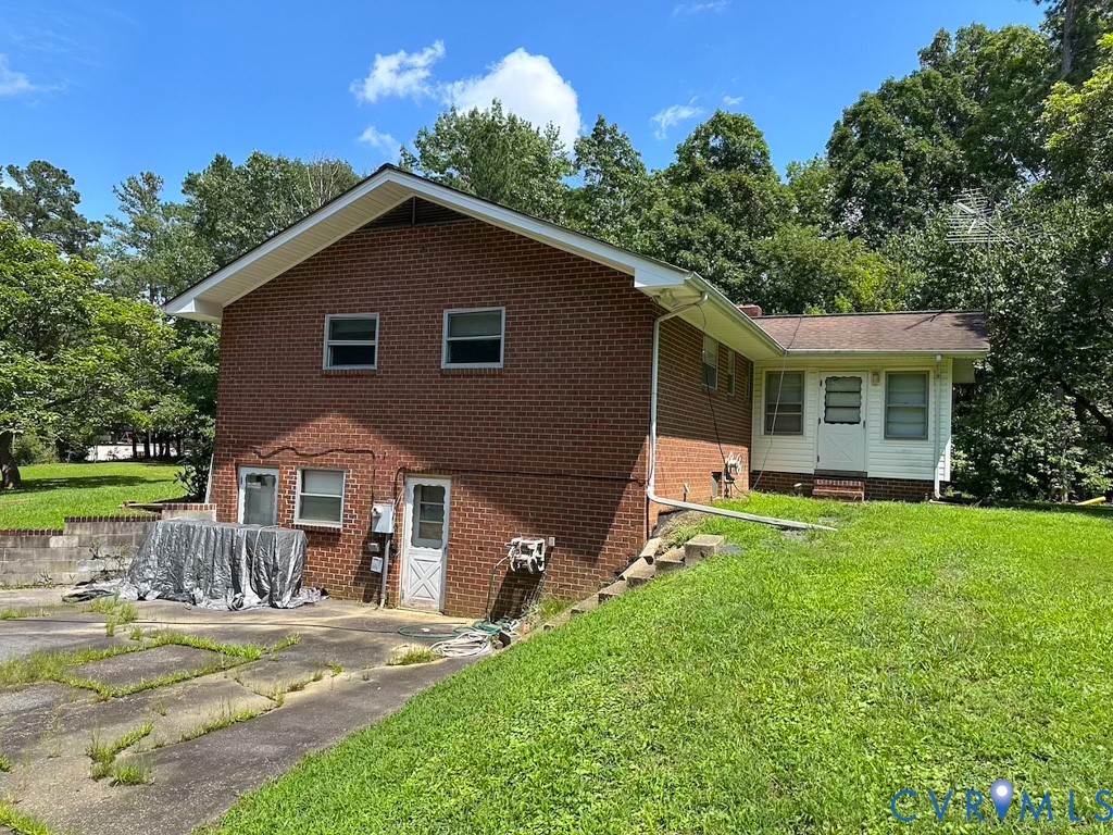9701 Old Stage Road Prince George, VA 23875 - Photo 3 of 29 a front view of a house with a yard