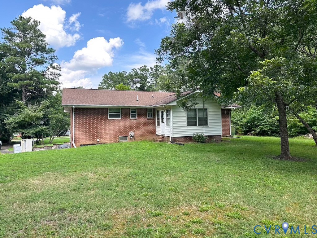 9701 Old Stage Road Prince George, VA 23875 - Photo 4 of 29 a front view of a house with a garden