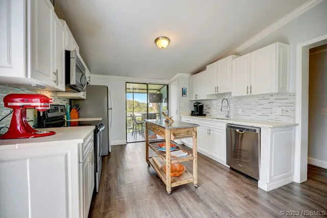a kitchen with a stove top oven and cabinets